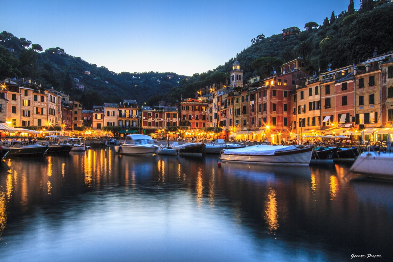 A view of boats in the water at night.