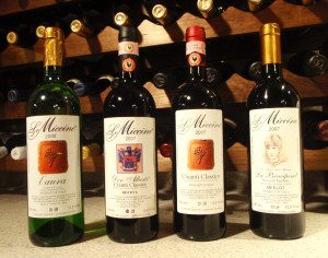 A group of four bottles of wine on top of a counter.