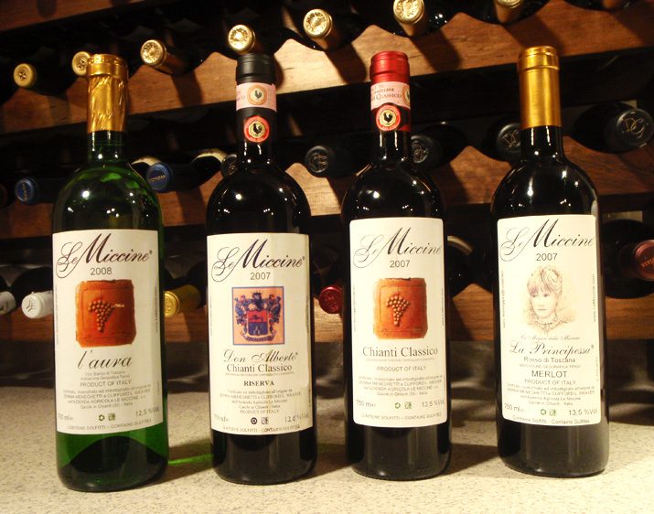 A group of four bottles of wine on top of a counter.