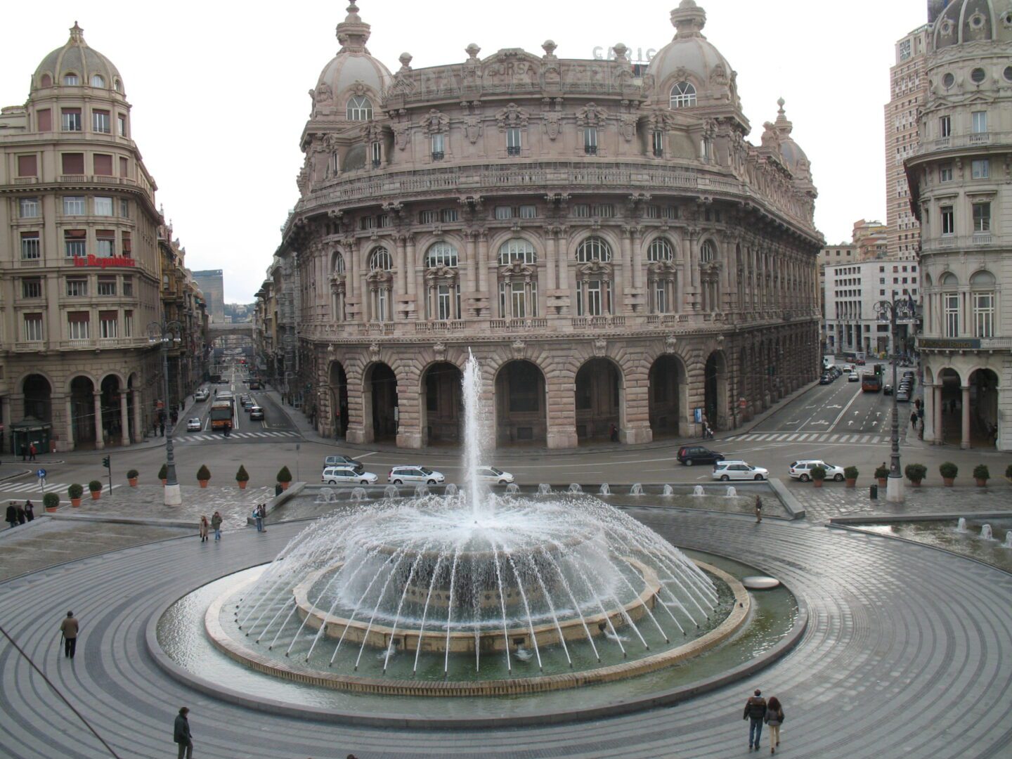 A fountain in front of an old building