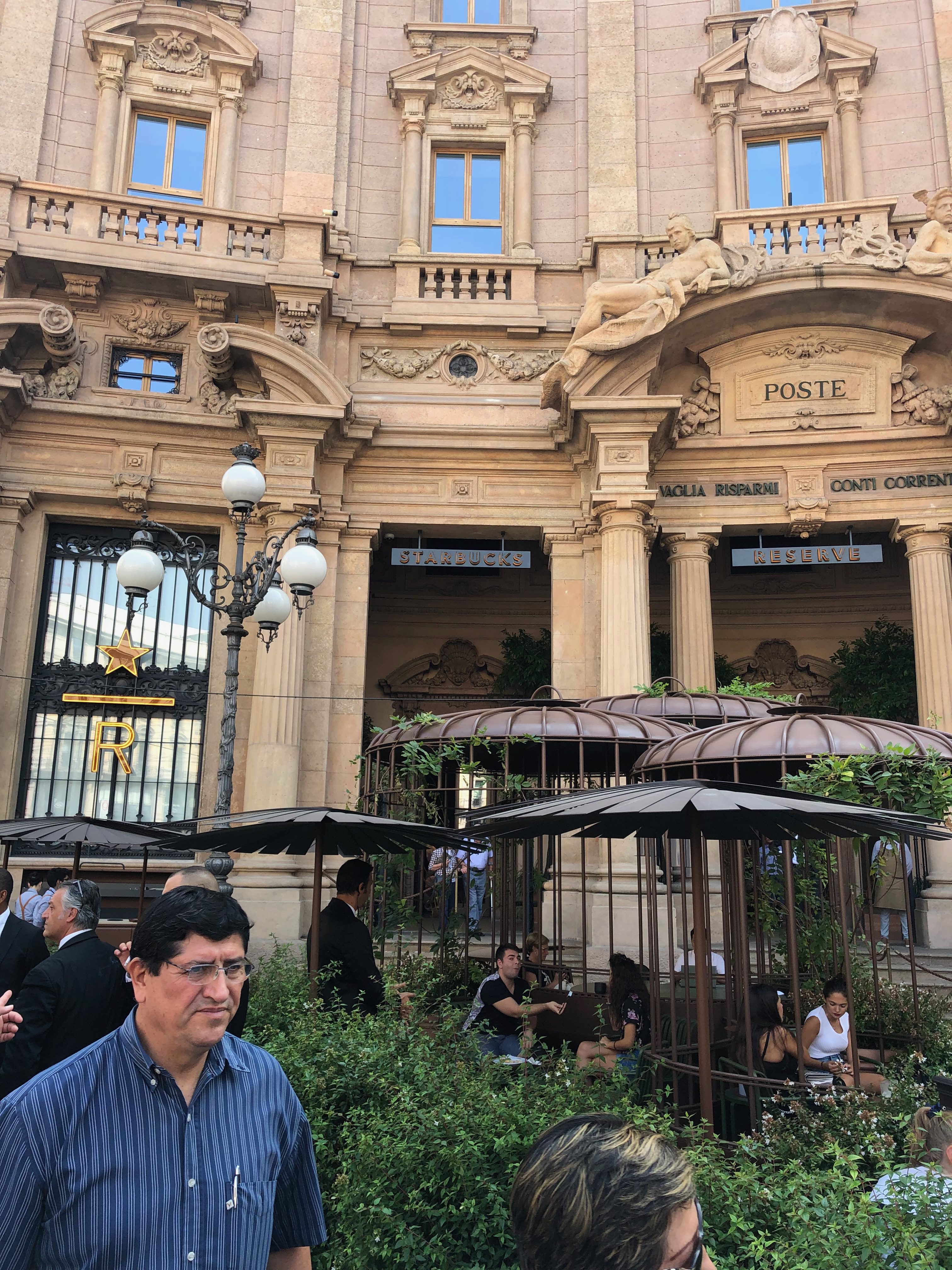 A man standing in front of an old building.