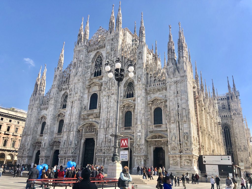 A cathedral with people walking around it
